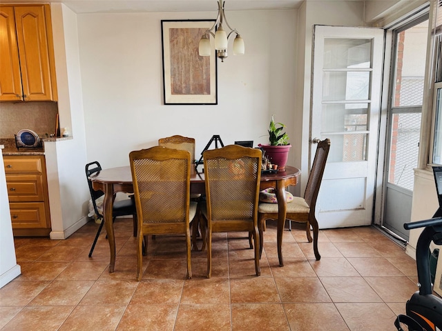 dining room featuring light tile patterned floors, a notable chandelier, and a wealth of natural light