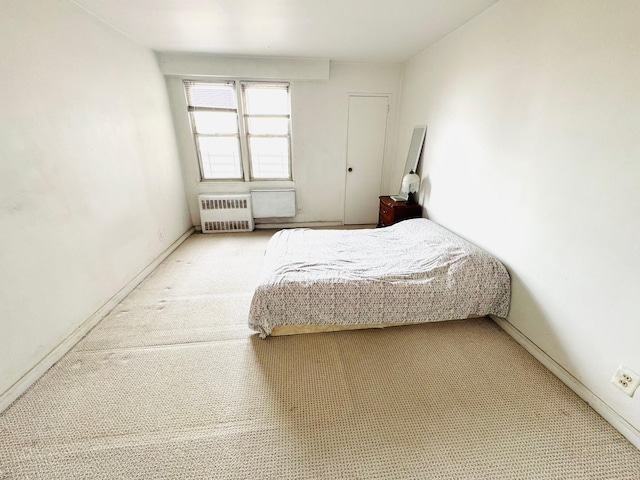 carpeted bedroom with radiator