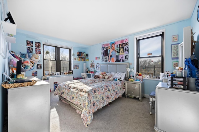 bedroom featuring multiple windows and carpet