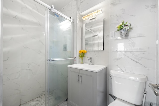 bathroom with toilet, tile walls, vanity, and walk in shower