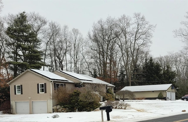 view of snow covered exterior with a garage