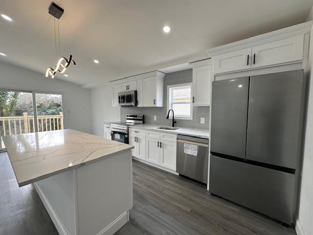 kitchen with white cabinetry, appliances with stainless steel finishes, sink, and pendant lighting