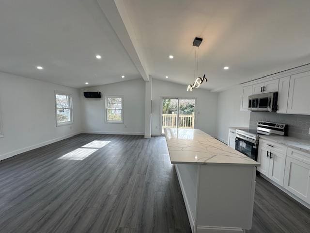 kitchen featuring vaulted ceiling with beams, hanging light fixtures, appliances with stainless steel finishes, dark hardwood / wood-style floors, and white cabinets