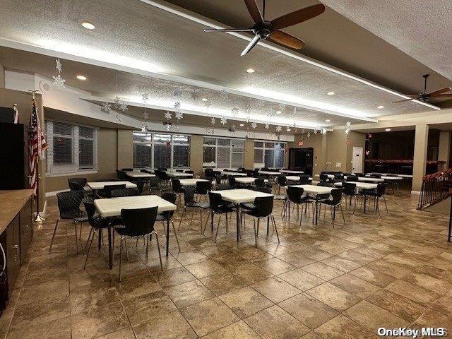 dining area with a textured ceiling and ceiling fan