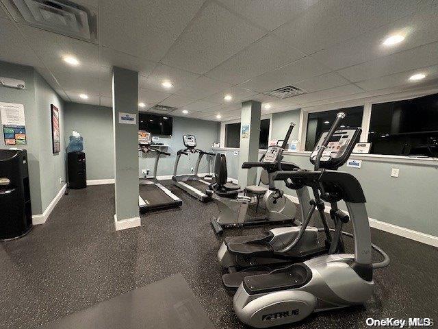 workout area with a paneled ceiling