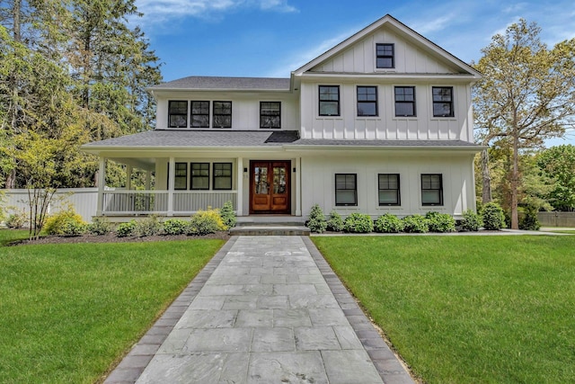 view of front facade with a porch, a front lawn, and french doors