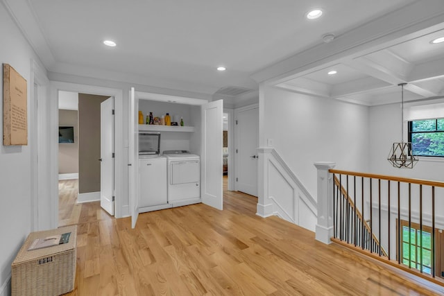 bar featuring beamed ceiling, crown molding, coffered ceiling, washing machine and dryer, and light wood-type flooring