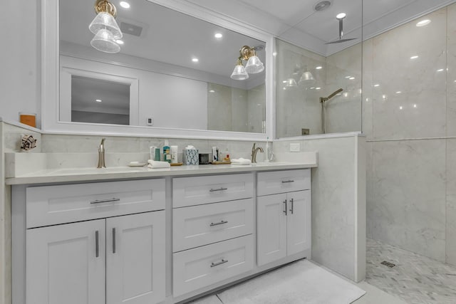 bathroom with vanity and a tile shower