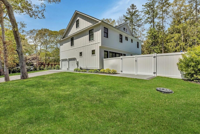 view of property exterior featuring a garage and a lawn