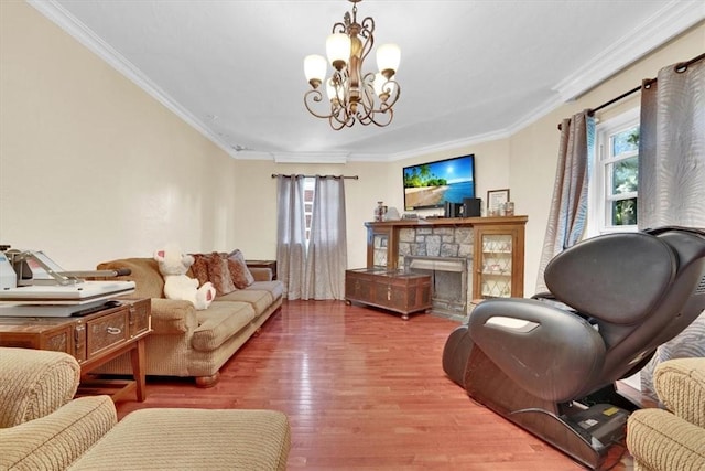 living room with ornamental molding, a stone fireplace, a wealth of natural light, and light wood-type flooring