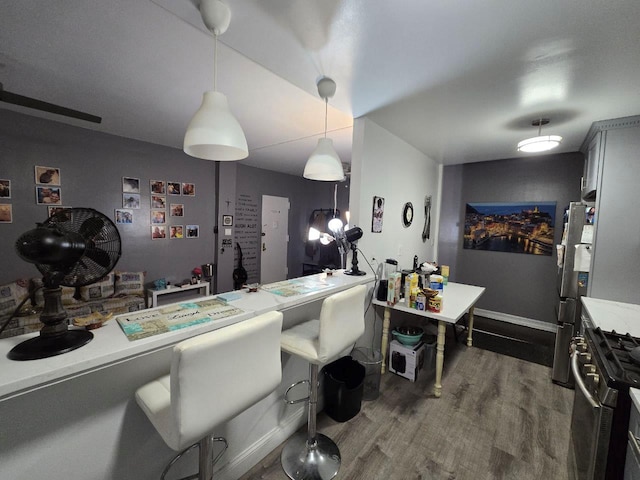 kitchen with dark hardwood / wood-style flooring, decorative light fixtures, gray cabinets, and appliances with stainless steel finishes