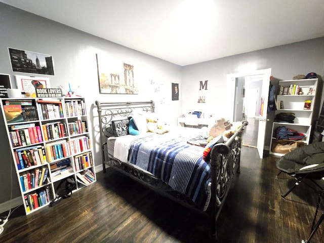 bedroom with dark hardwood / wood-style flooring