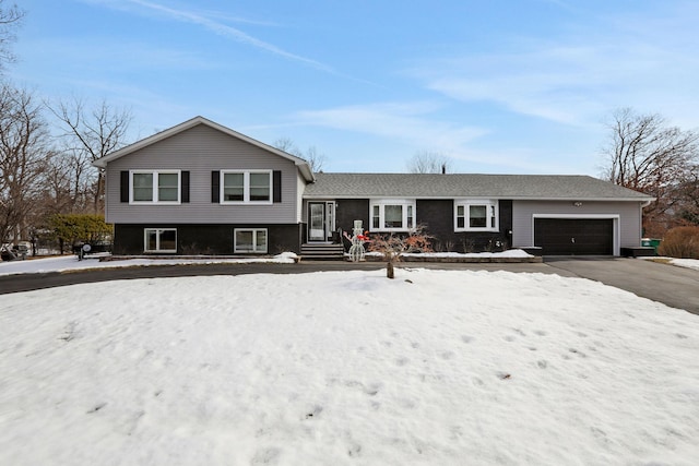 tri-level home with an attached garage and driveway