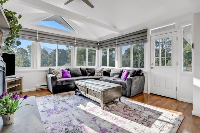 sunroom with a baseboard heating unit, ceiling fan, and vaulted ceiling