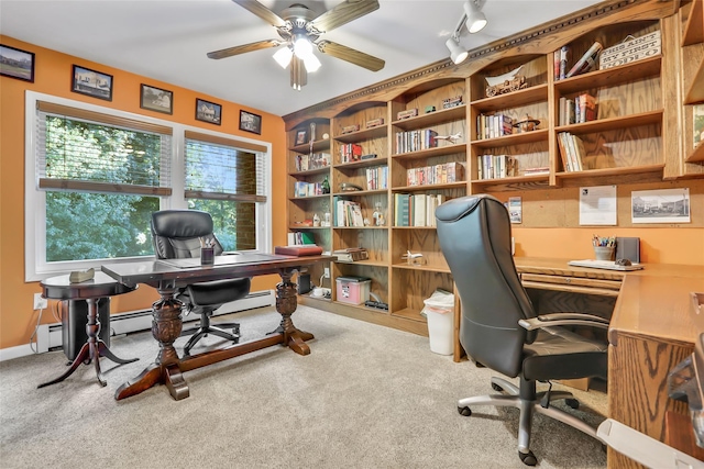 carpeted office space featuring a baseboard radiator, rail lighting, a ceiling fan, and baseboards