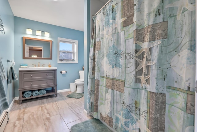 full bath featuring baseboard heating, baseboards, vanity, and toilet