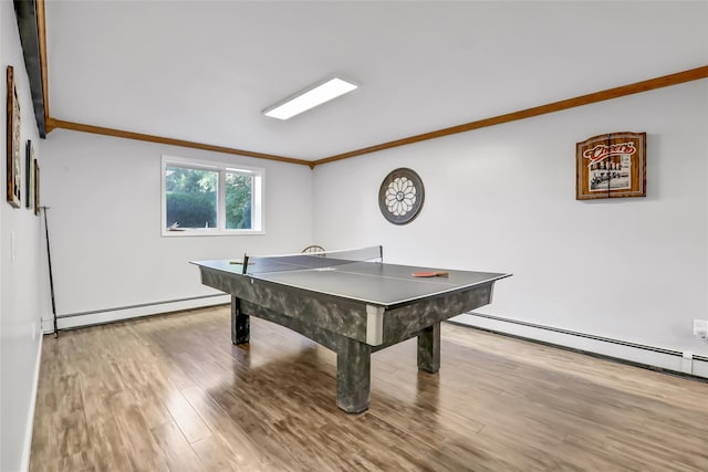 playroom featuring ornamental molding, a baseboard radiator, baseboard heating, and wood finished floors