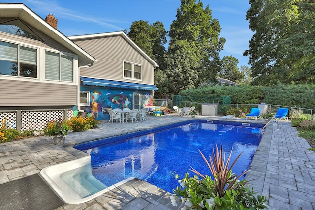 view of swimming pool with a fenced in pool, a fenced backyard, and a patio