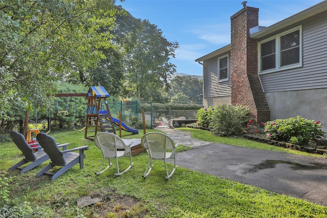 view of play area with a lawn and fence