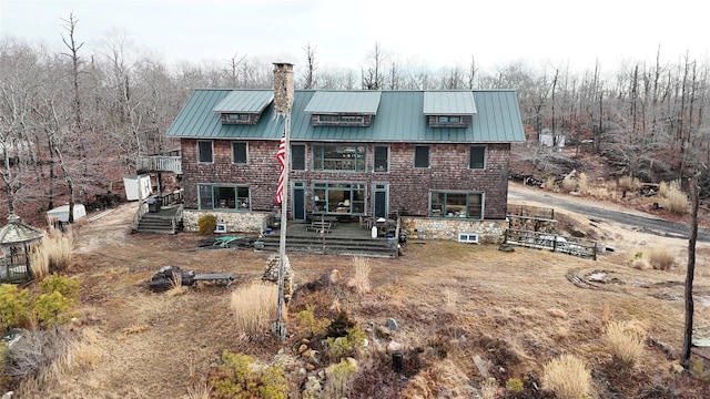 back of property featuring a wooden deck