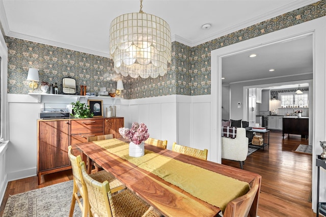 dining room featuring crown molding, dark hardwood / wood-style floors, and a notable chandelier