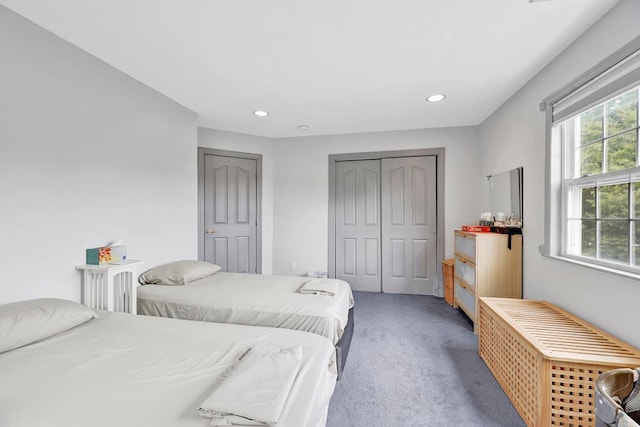 bedroom with carpet flooring and a closet