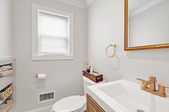 bathroom featuring vanity, crown molding, and toilet