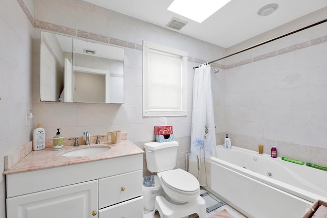 full bathroom with toilet, tile walls, vanity, shower / bath combination with curtain, and backsplash