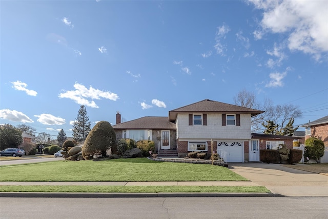 tri-level home featuring a garage and a front yard