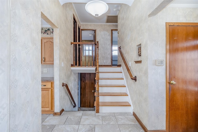 staircase with crown molding