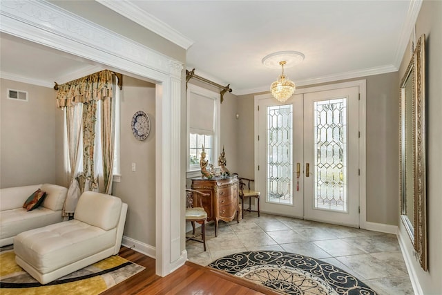 entryway featuring visible vents, french doors, and ornamental molding