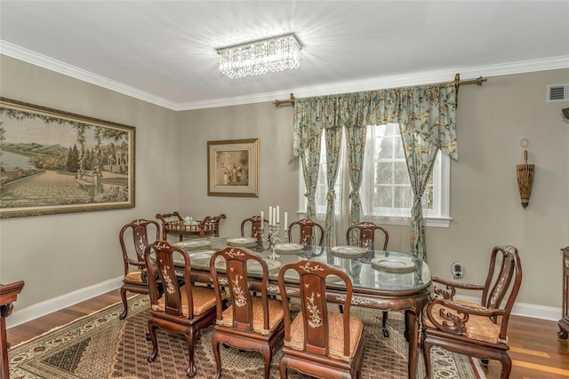 dining room featuring ornamental molding, wood finished floors, and baseboards