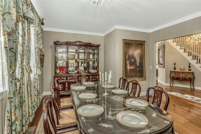 dining space featuring hardwood / wood-style floors and ornamental molding