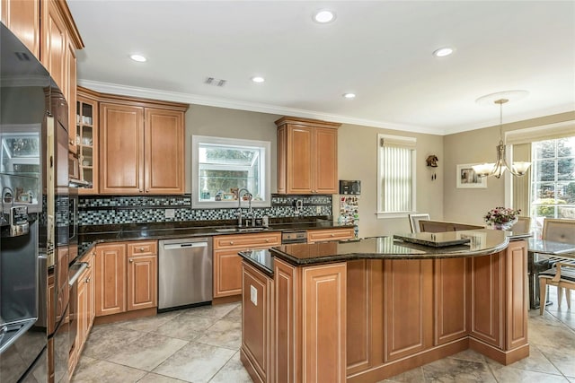 kitchen with appliances with stainless steel finishes, a kitchen island, glass insert cabinets, and brown cabinets