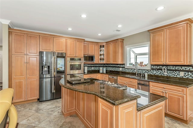 kitchen with dark stone counters, glass insert cabinets, a center island, stainless steel appliances, and a sink