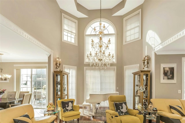 living room featuring a chandelier and ornamental molding