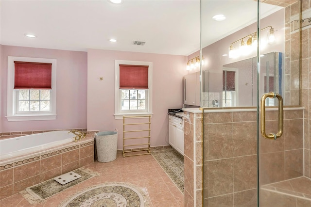 bathroom with tile patterned flooring, vanity, a wealth of natural light, and plus walk in shower