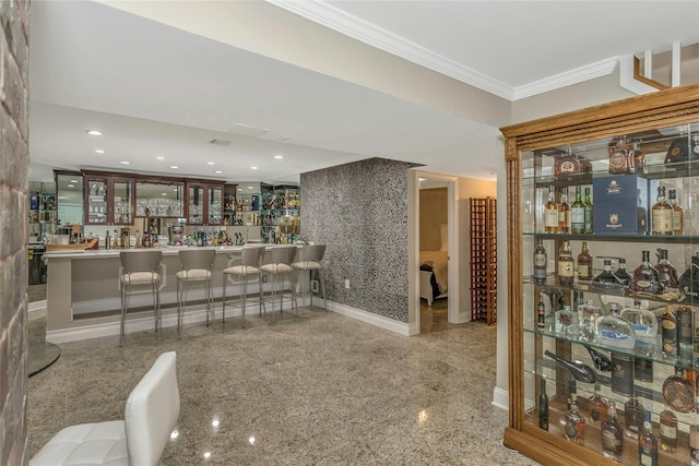 bar featuring baseboards, crown molding, granite finish floor, indoor wet bar, and recessed lighting