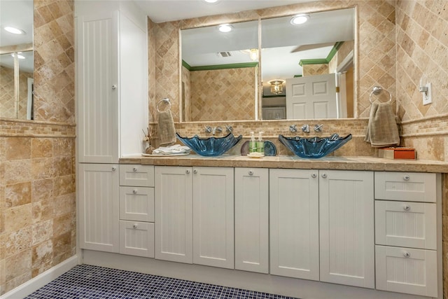 bathroom with tasteful backsplash, vanity, tile patterned flooring, and tile walls