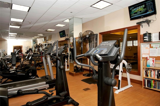 gym with a paneled ceiling