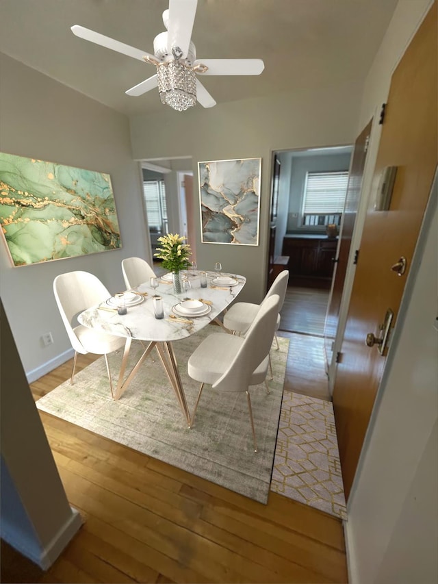 dining room with ceiling fan and light wood-type flooring