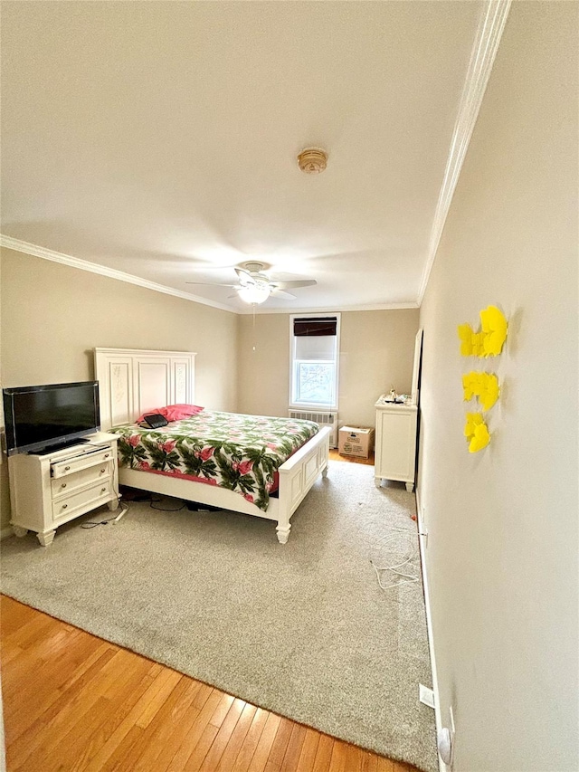 bedroom featuring ornamental molding, ceiling fan, and light hardwood / wood-style floors