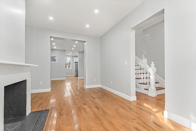 unfurnished living room with light hardwood / wood-style flooring