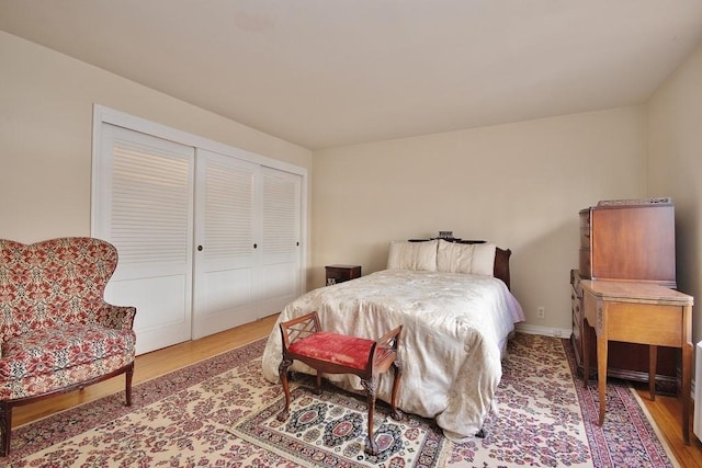 bedroom with hardwood / wood-style flooring and a closet