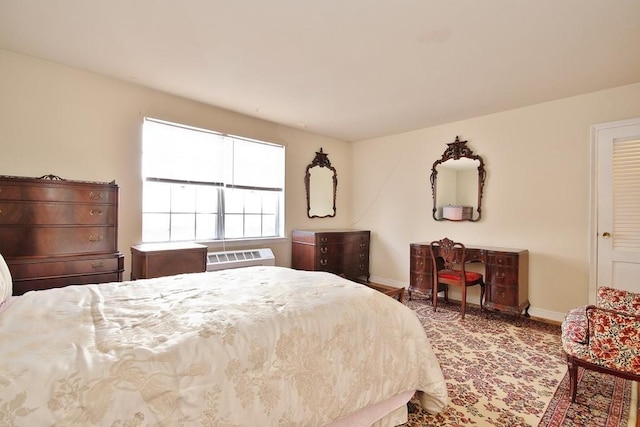 bedroom with an AC wall unit