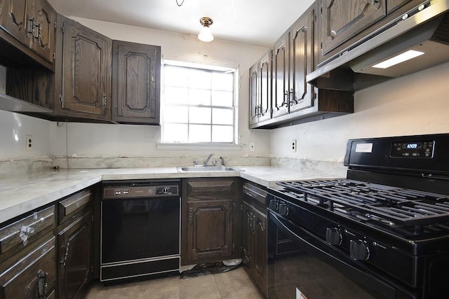 kitchen featuring dark brown cabinetry, sink, and black appliances