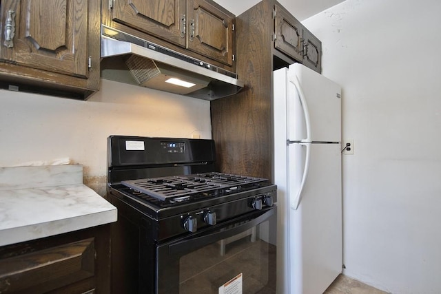 kitchen with black gas range and white fridge