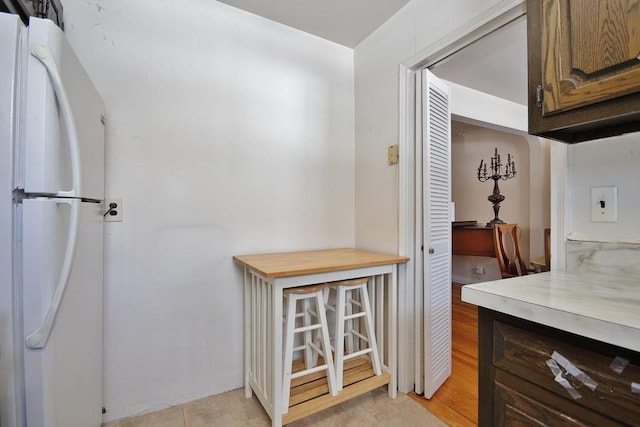 kitchen featuring white refrigerator and light hardwood / wood-style floors