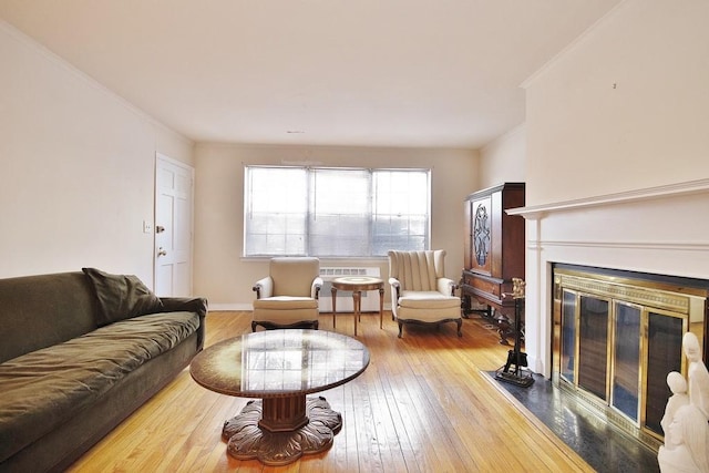 living room featuring crown molding and hardwood / wood-style flooring