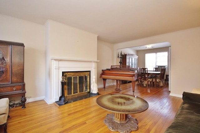 living room with ornamental molding and hardwood / wood-style floors